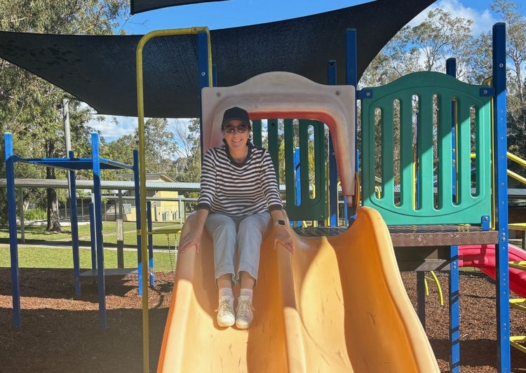 A staff member on the school play equipment