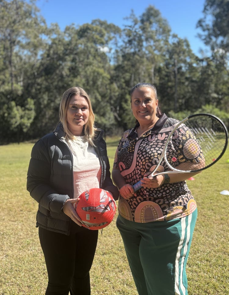 Two school teachers with sports equipment