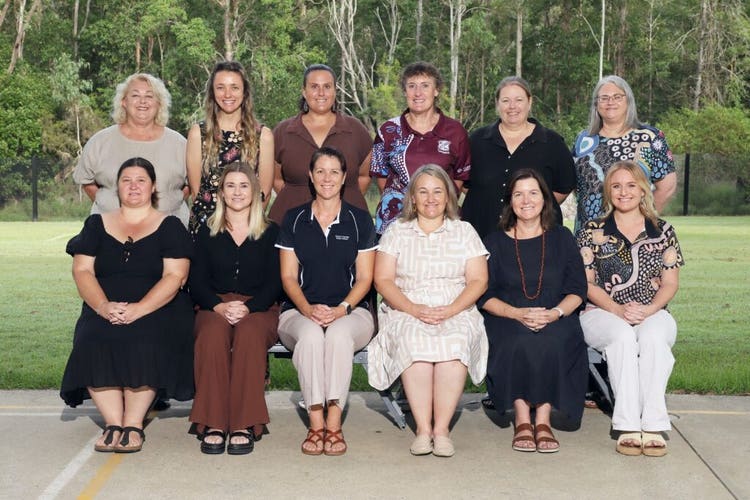A group photo of twelve school staff on school photo day