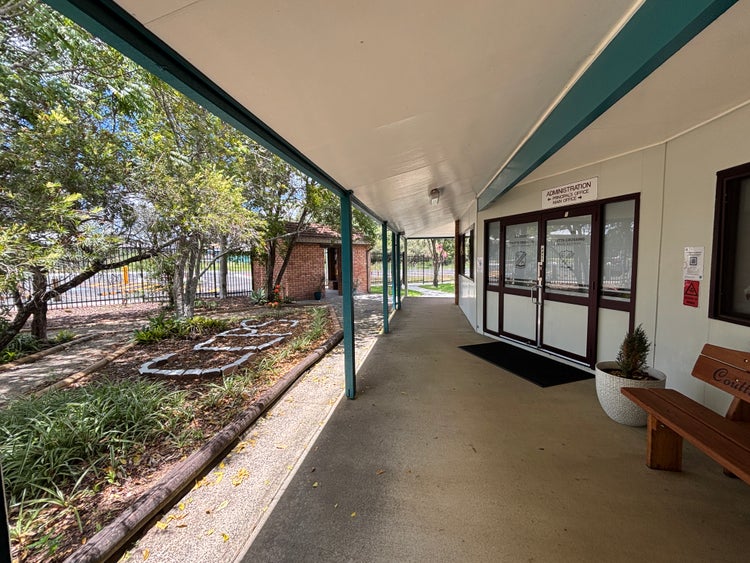 The front of the school administration building and adjacent garden