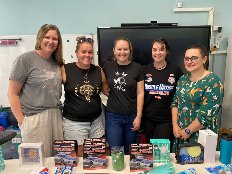 A photo of five parent volunteers selling gifts for fathers day